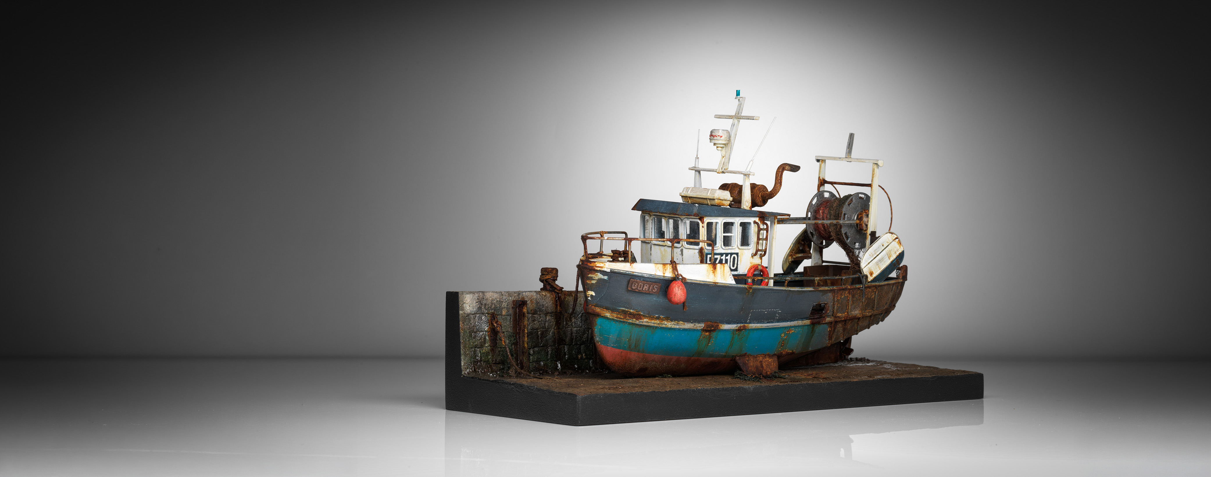 Doris 002, a weathered fishing vessel in her harbour setting